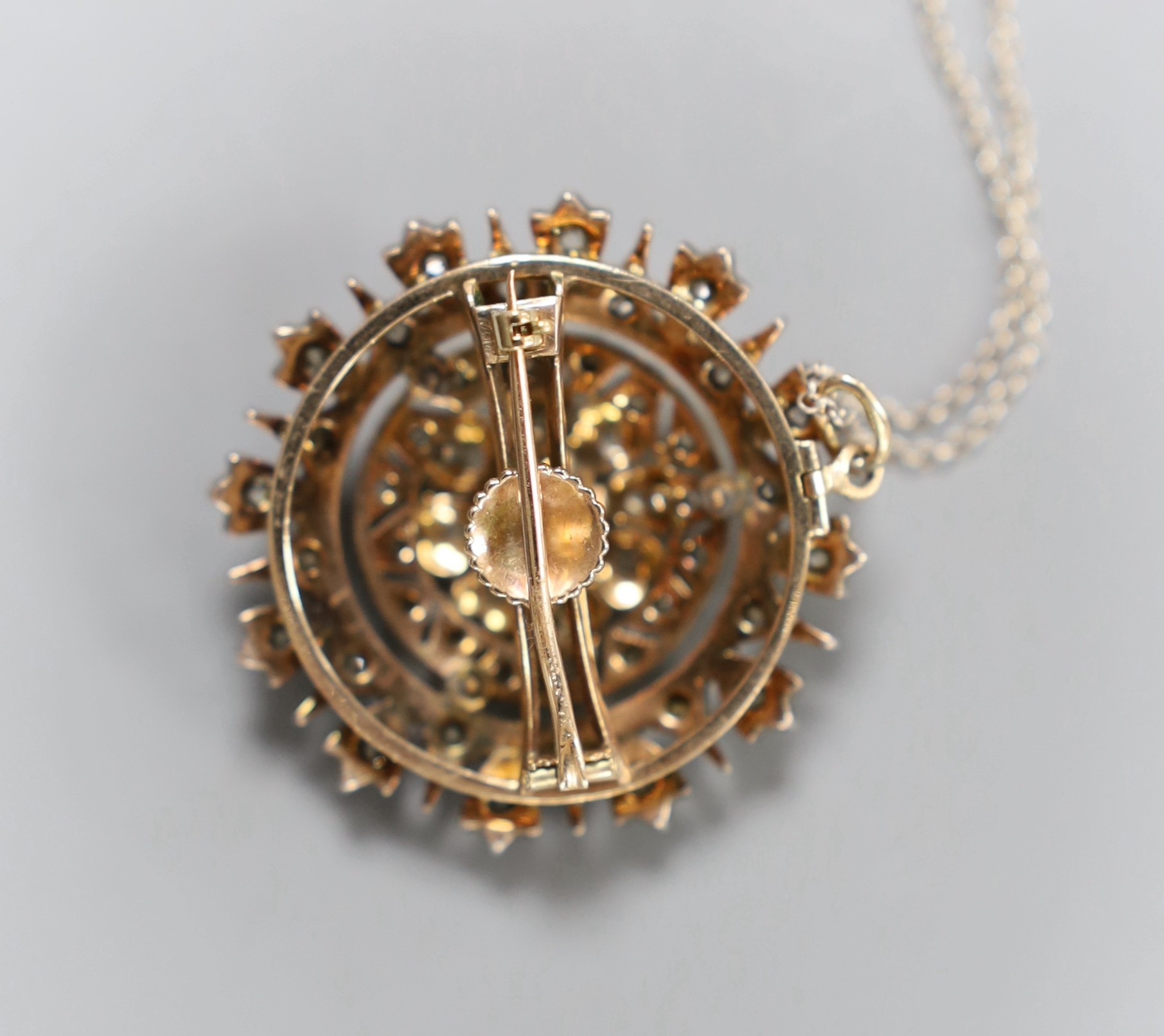 A late Victorian gold silver and diamond circular cluster pendant brooch, 3.5cm, gross 17.5 grams